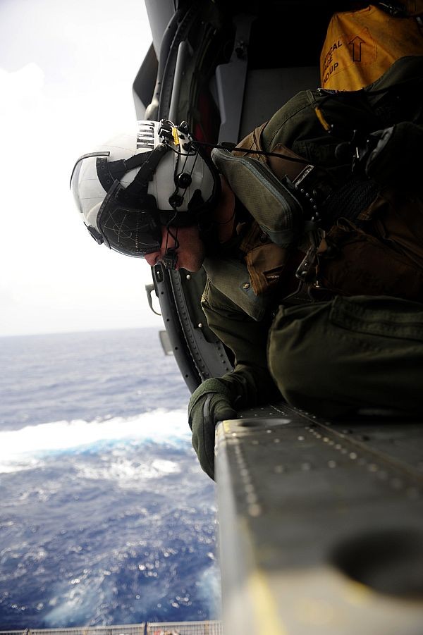 Một binh sỹ của Hải quân Mỹ đang quan sát tàu sân bay USS John C. Stennis từ cabin của một chiếc trực thăng MH-60S Sea Hawk. Đây là những trực thăng thuộc biên chế của phi đội bay trực thăng chiến đấu trên biển của hàng không mẫu hạm USS John C. Stennis (ảnh ngày 31/8/2011).